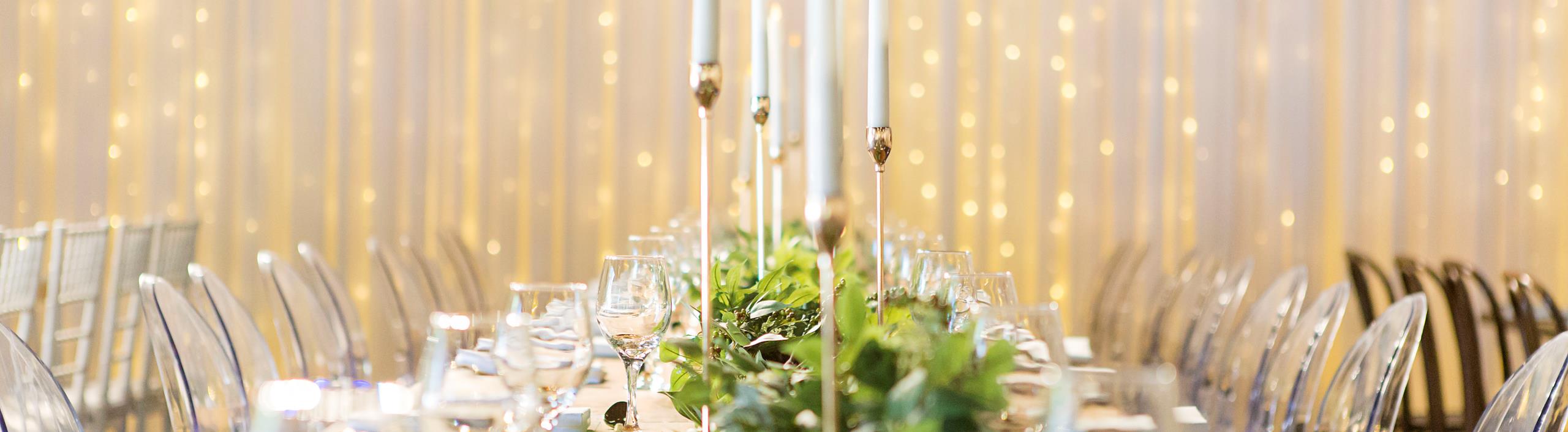 Candles  and elegantly decorated dining table creates a magical setting for a wedding. 