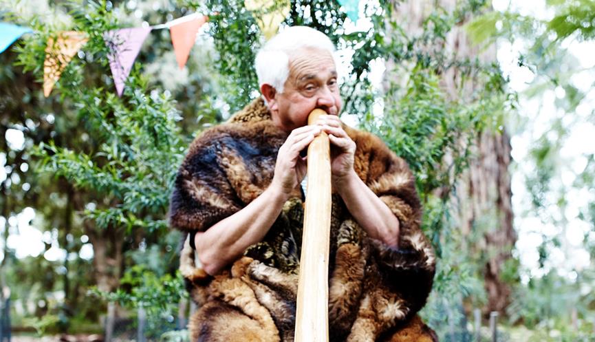 Murrundindi playing the Didgeridoo in the garden at Healesville Sanctuary.