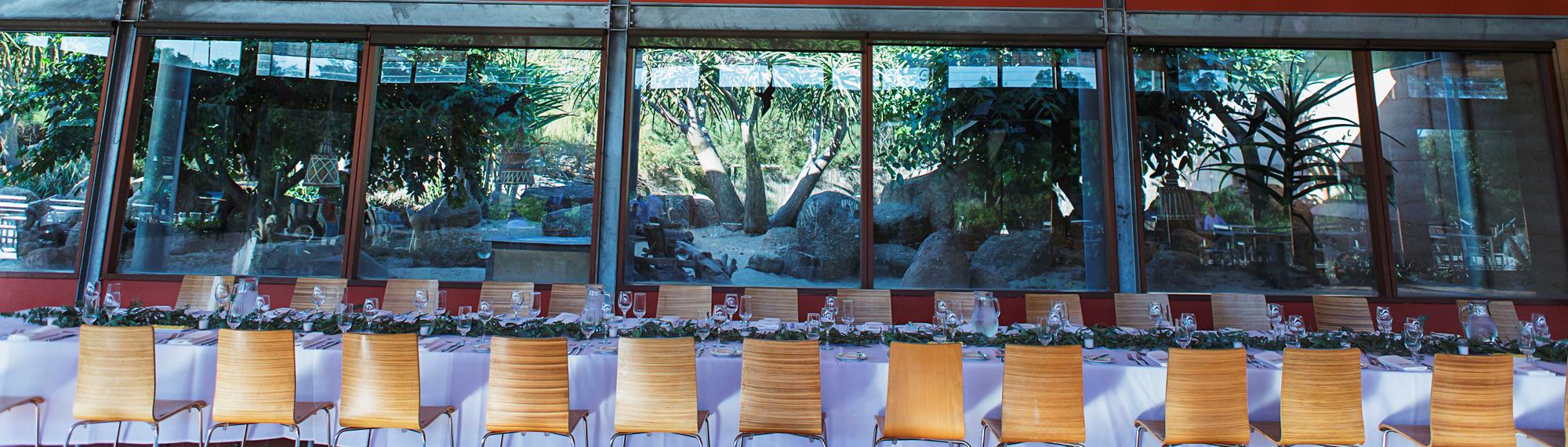 Meerkat Bistro private function area with a long formal set table positioned in front of windows over looking the meerkat enclosure.