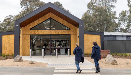 Two people walk to the front entrance of Kyabram Fauna Park